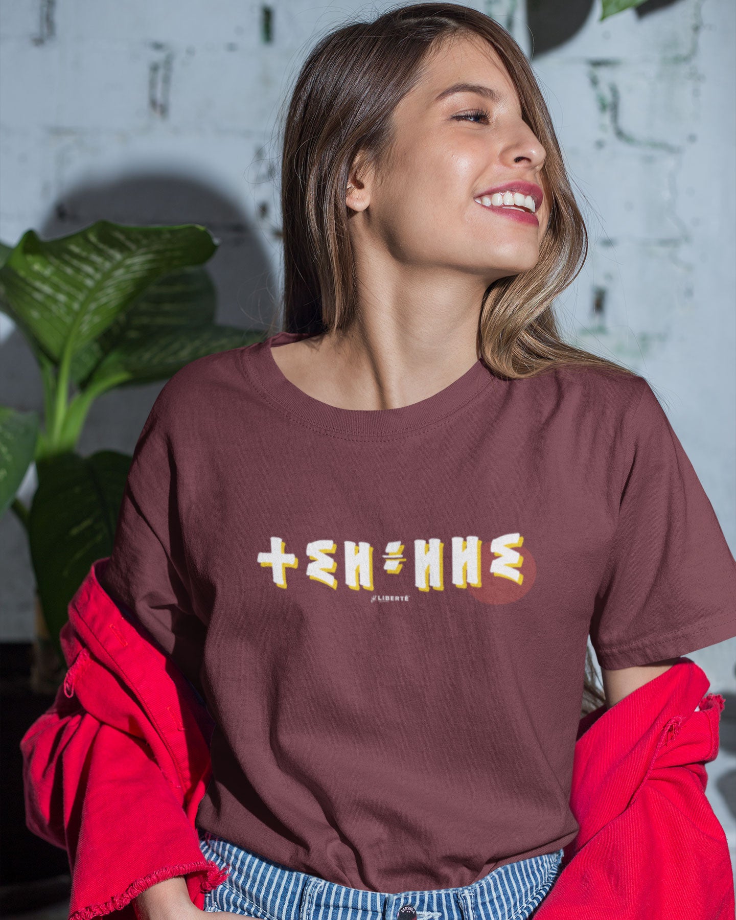 T-shirt Azamoul Thilelli écrit en lettre Tifinagh alphabet berbère amazigh porté par une femme souriante - couleur bordeaux - 100% coton bio made in france